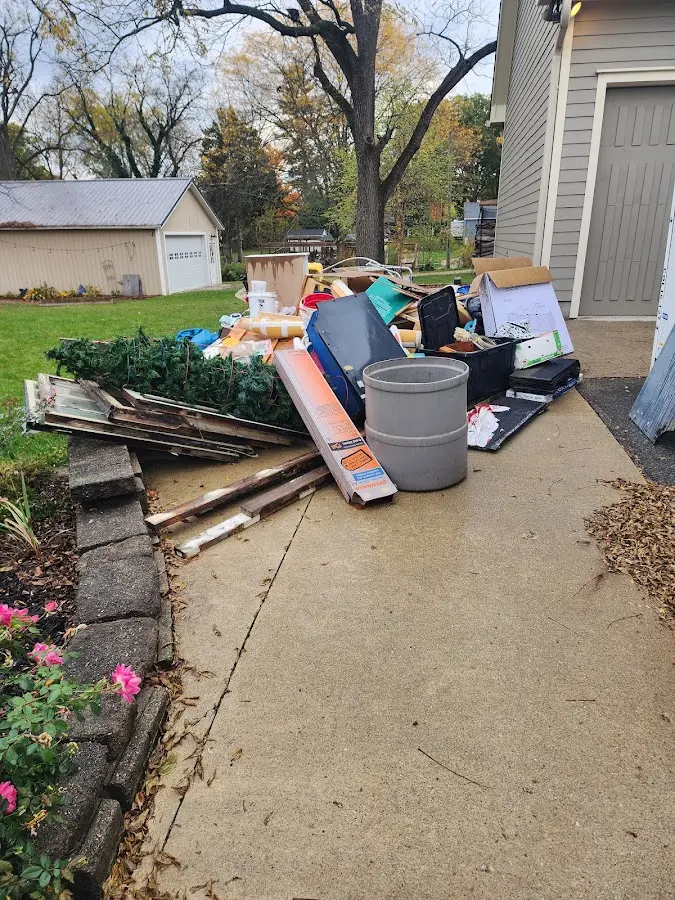 Dumpster being loaded with debris for 12 Yard Dumpster Rental in County Center
